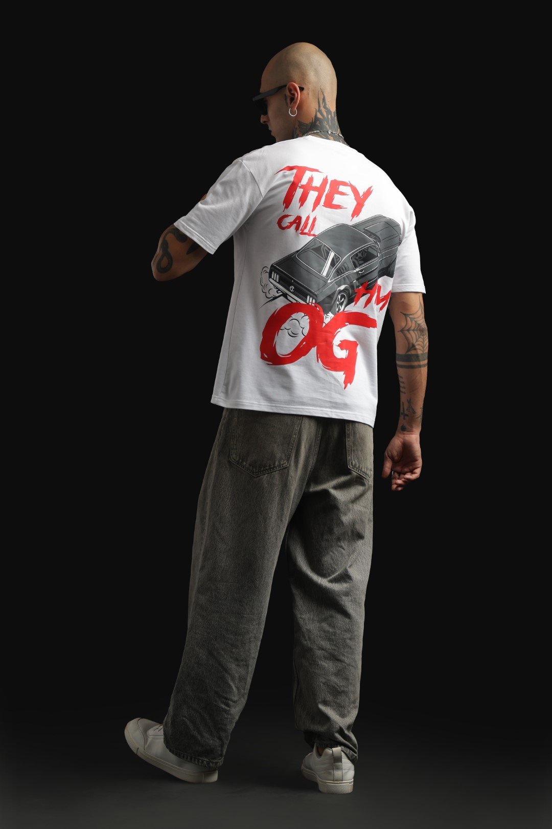 White oversized T-shirt featuring a graphic of a Ford Mustang drifting.