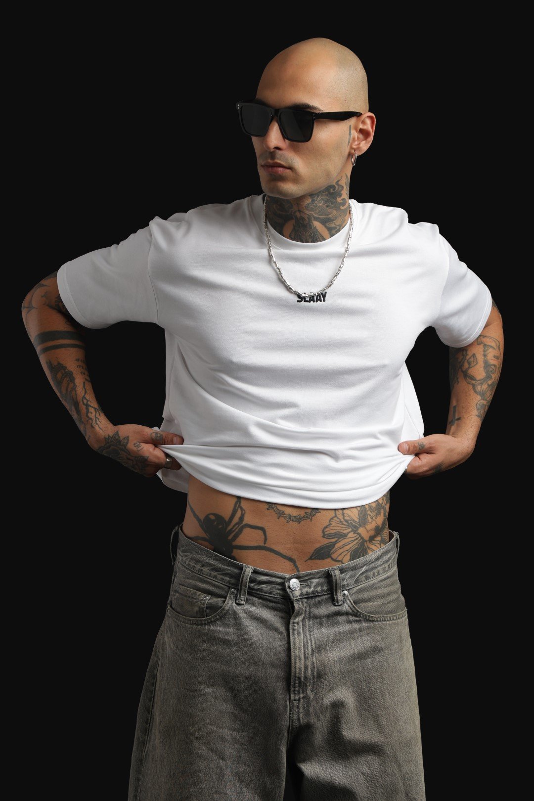 White oversized T-shirt featuring a graphic of a Ford Mustang drifting.