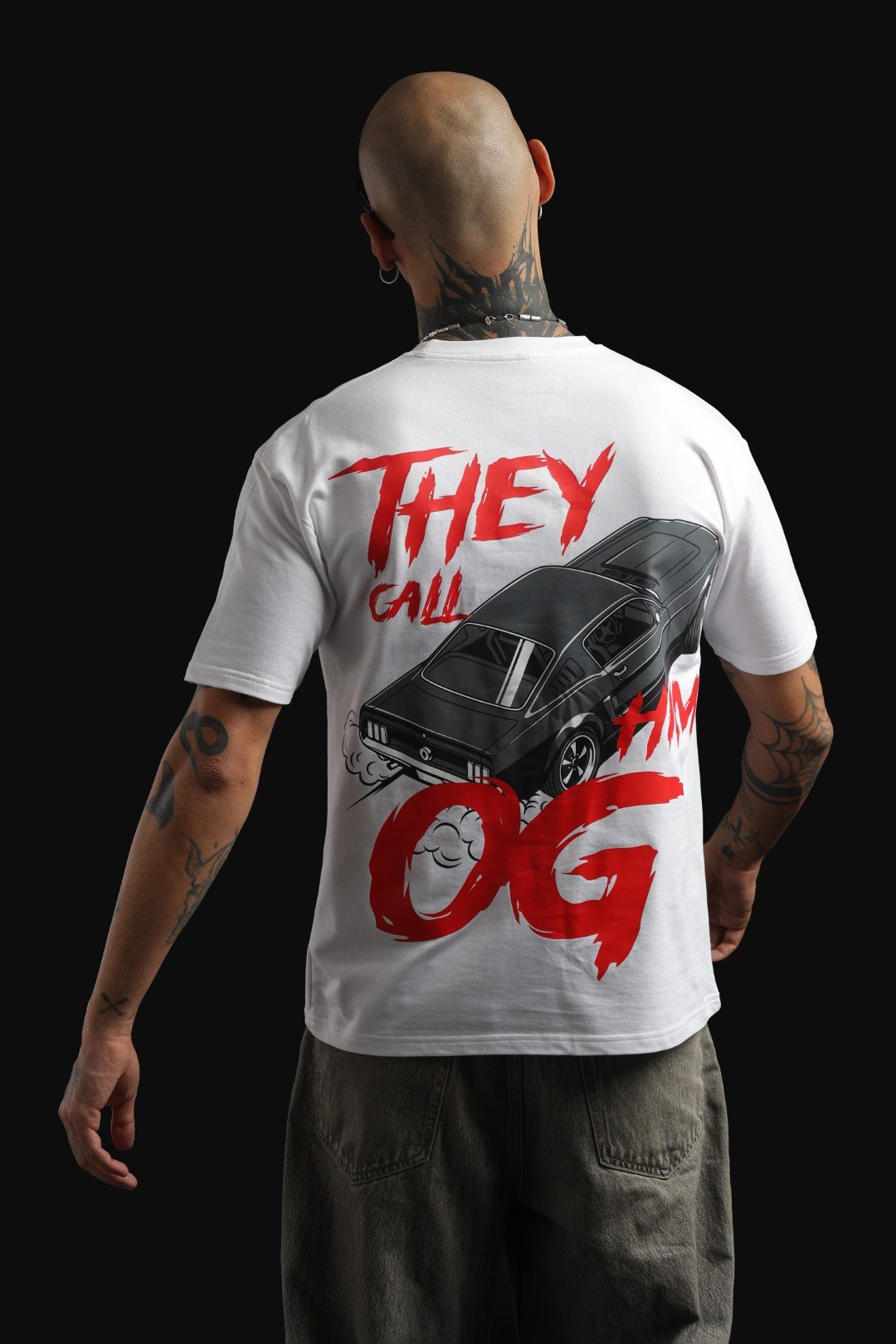 White oversized T-shirt featuring a graphic of a Ford Mustang drifting.